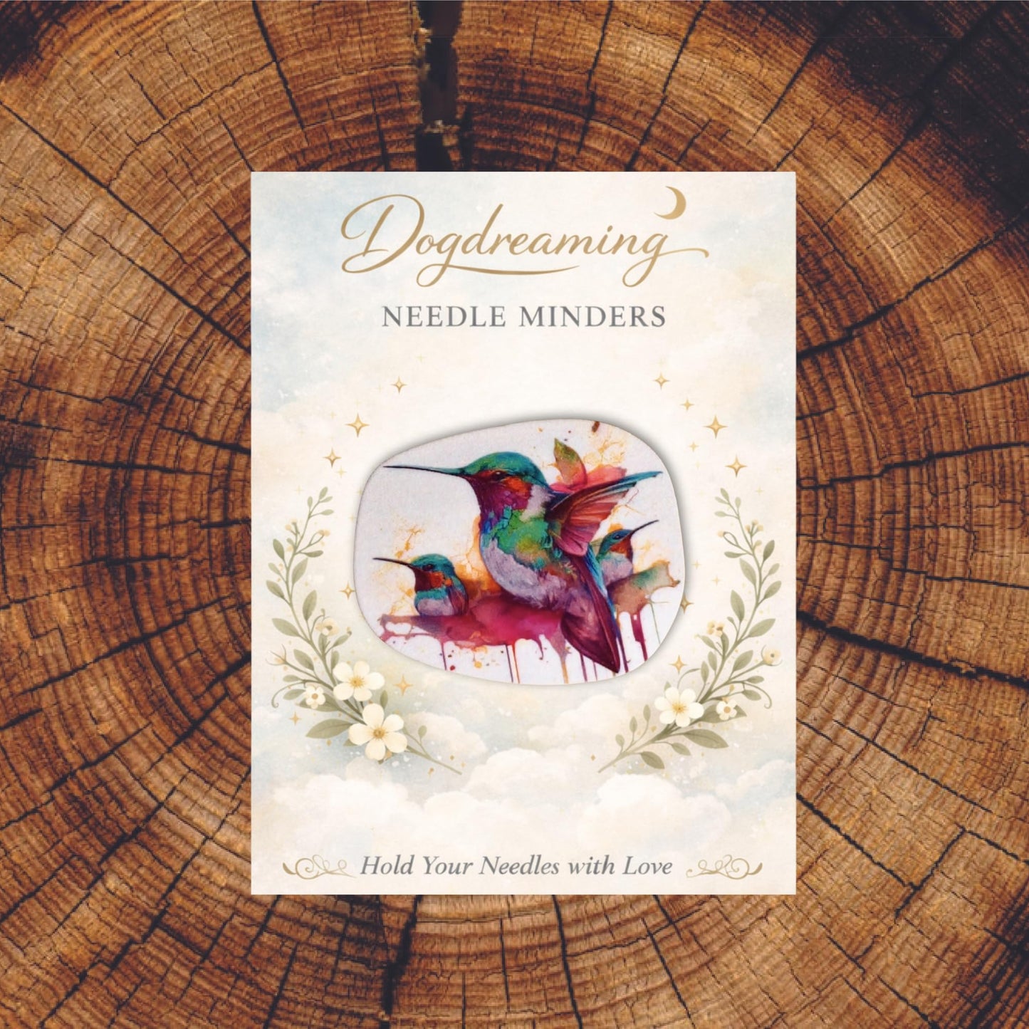 Colorful watercolor hummingbird magnetic needle minder featuring vibrant teal, purple, and pink birds in artistic paint splash style.