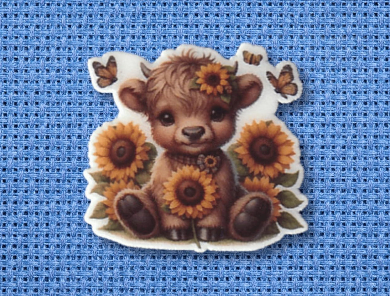 Sweet baby Highland cow needle minder with sunflower crown and butterflies