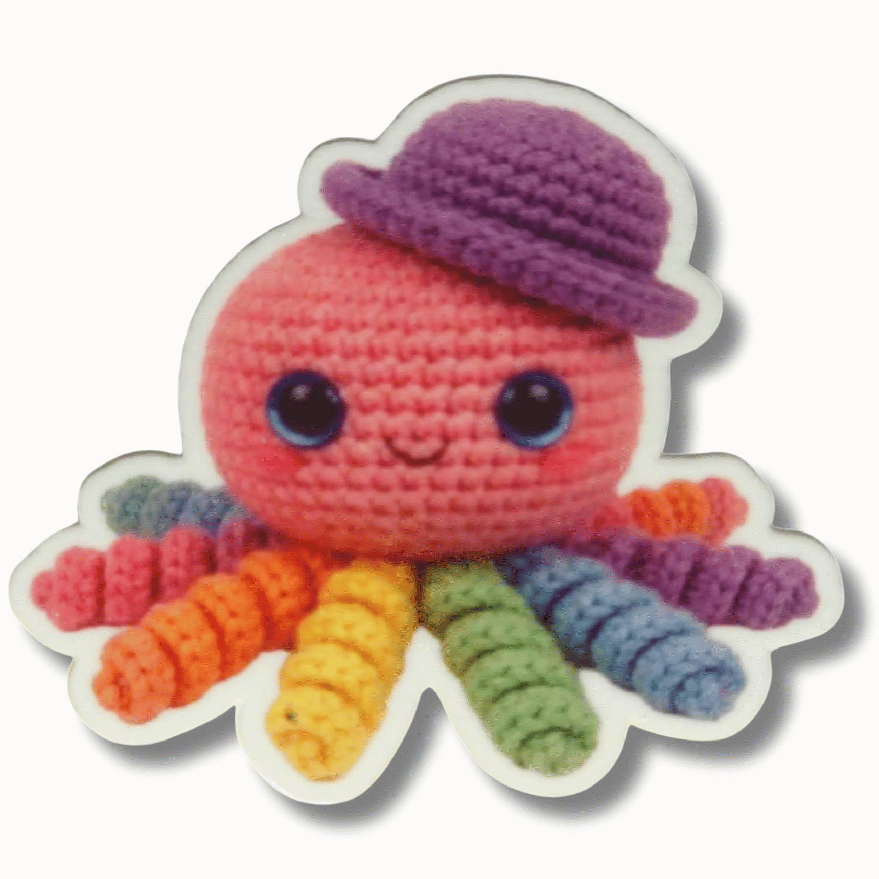Rainbow crochet octopus magnetic needle minder with a purple hat and colorful plush tentacles for cross stitch and embroidery