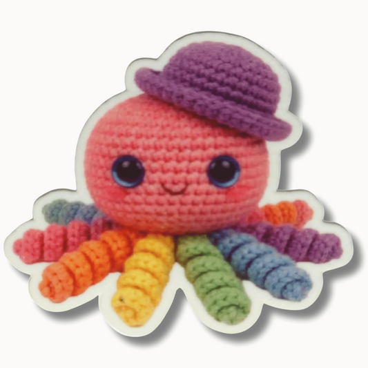 Rainbow crochet octopus magnetic needle minder with a purple hat and colorful plush tentacles for cross stitch and embroidery