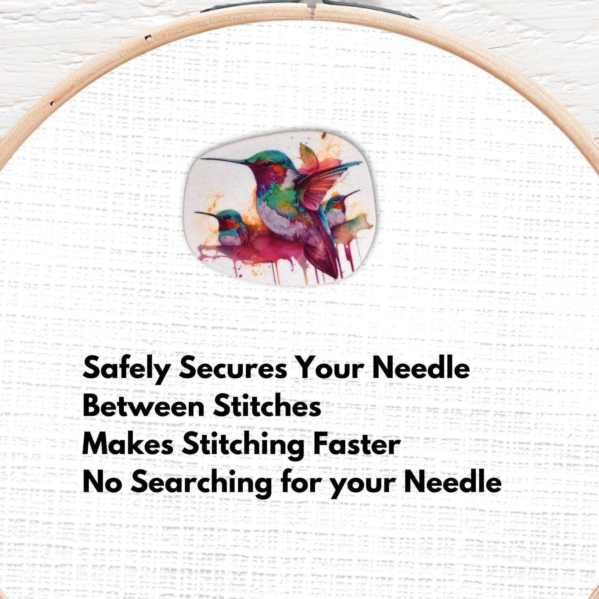 Vibrant hummingbird magnetic needle holder with multicolor feathers in teal, emerald, magenta, and coral tones for cross stitch and embroidery.