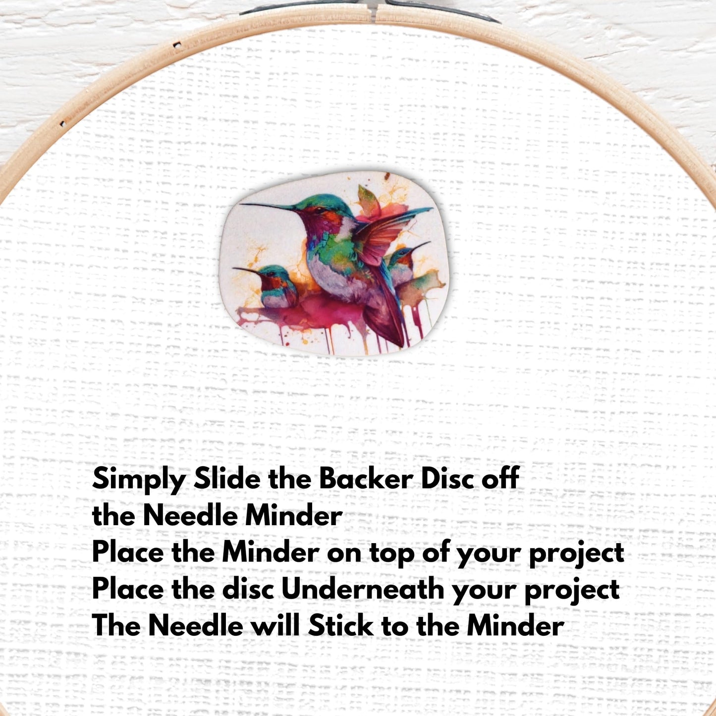 Artistic hummingbird needle minder with bright watercolor paint splashes, perfect for nature-themed sewing projects.